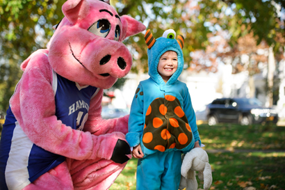 Matilda Terrell, 3, hangs out with Al Ham at Fall Fest. Matilda's mom is Assistant Professor of English Katherine Terrell.