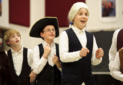 From left Clinton students Jack Inzer, Nicholas Frank and Charles Bonham are coached before their presentation.