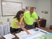 Aubrey Coon '16 reviews engineering schematics of shoreline restoration with Village of Sylvan Beach Administrator Joseph Benedict.