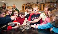 Students from Seneca Street School in Oneida visit with a snake in Prof. Dave Gapp's lab.