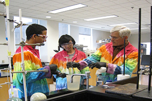 From left, Felipe Garcia '14, Joshua Ho '15 and Professor of Chemistry Tim Elgren work in a lab.
