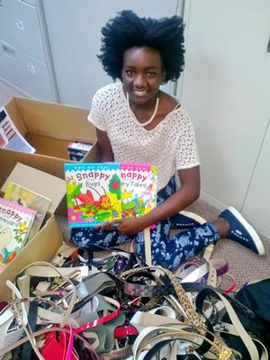Jorett Joseph '15 sorts donated books and belts for the orphanage she's working with in Haiti.