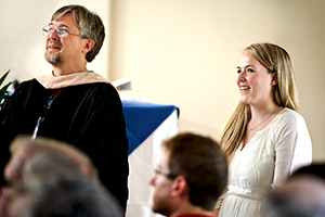 Riley Stepnick '12 with Professor of Music Sam Pellman listens to her song performed by the Choir at Class & Charter Day.