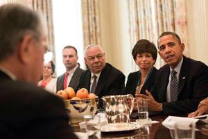 Thomas Tull '92, back left, seated next to retired Gen. Colin Powell, at the White House discussion of President Obama's