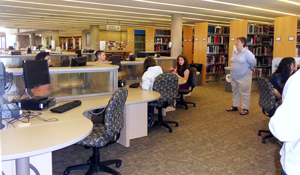 Research Librarian Kristin Strohmeyer assists local high school students in Burke Library.