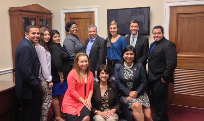 Monique St. Jarre, standing third from right, at an event for World Day Against Child Labor. At center in chair is Rep. Lucille Roybal-Allard, who is supporting a bill for the group.