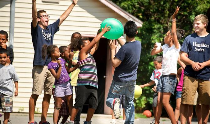 Members of the Class of 2017 play games with children at the Neighborhood Center in Utica as part of Hamilton Serves.