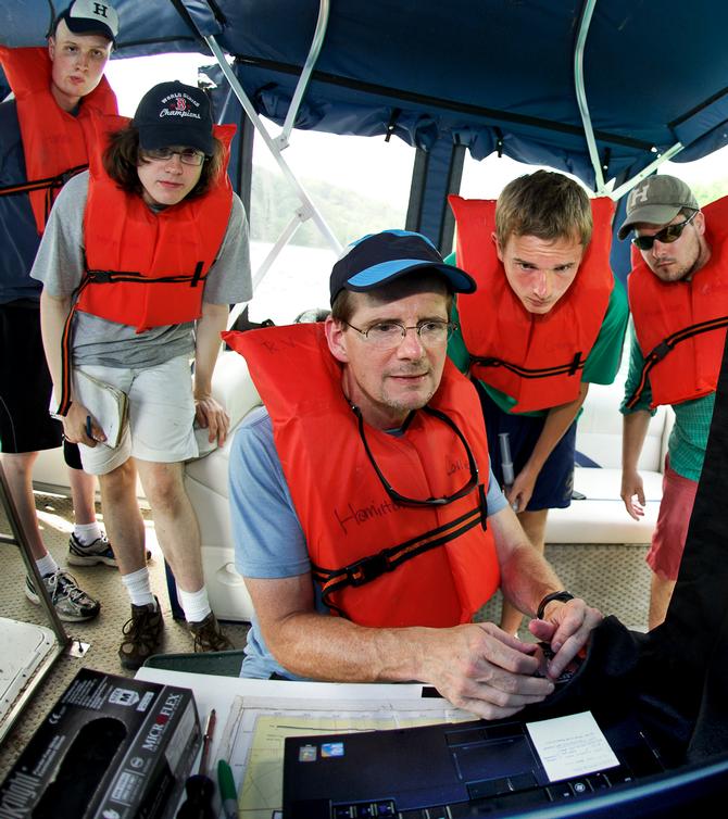 Prof. Mike McCormick maneuvers the remotely operated vehicle looking for a spot to collect bacteria samples from Green Lake. Looking on are Kevin Boettger, Matt Brzustoski, Rob Clayton and Daniel Lichtenauer.