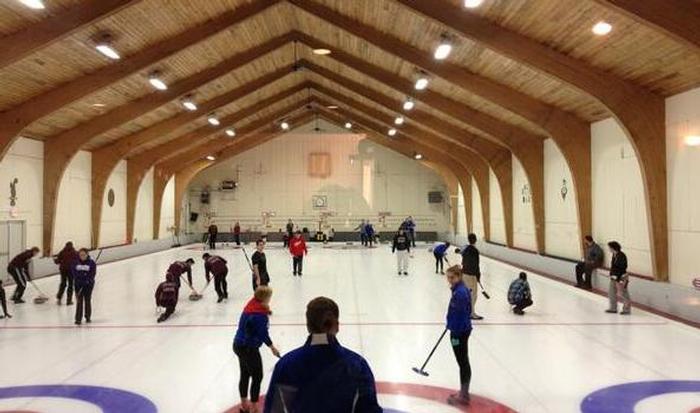The team competing at Broomstones Curling Club in Wayland, Mass. Trevor Howe '14 is getting ready to throw the stone