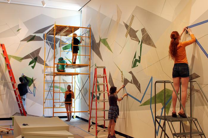 Students help artist Danielle Tegeder complete a 70-foot wall drawing in the Wellin Museum of Art. PHOTO: BY VICTORIA LIN '15