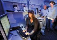 Spencer Gulbronson '12 (seated), Stu Hirshfield and Leanne Hirshfield '02 measure cognitive and emotional brain responses using non-invasive techniques.