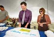 Dean of Faculty Patrick Reynolds and President Joan Hinde Stewart cut one of three birthday cakes for employees. 