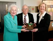 Kay Couper Watrous and Dick Couper receive University medal from Binghamton president Lois DeFleur.