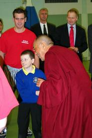 Mike Evans '05 (red shirt) met with the Dalai Lama (right) in Belfast.