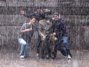 Shaan Gajria, Chris Smith, and Ayush Soni brave a downpour for a photo op with FDR.