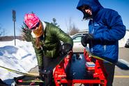 Team Captain McKayla Dunfey ’13 and Peter Skaggs ’16 put the finishing touches on their skis just before the start of the 20km race.
