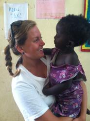 Hillary Kolodner '14 with a Senegalese child at the community center.