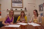 2010 Senior Gift Co-Chairs Julia Pollan '10 and Valerie Valent '10, alongside President Joan Hinde Stewart, sign the 2010 Senior Gift Environmental Sustainability Fund agreement. Not pictured: Senior Gift Co-Chair Megan Bumb '10. 