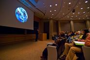 Josh Simpson displays one of his planets to the Kennedy Auditorium audience