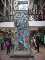 Students view a piece of the Berlin Wall, given as a gift to Montreal.