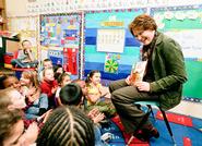 Dean of Students Nancy Thompson reads to kindergarten students at Kernan Elementary School.