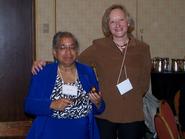 Classics professor Shelley Haley, left, accepts the CAAS gavel from outgoing president Sarolta Takacs of the Sage Colleges.