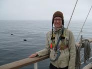 Ashleigh Smythe, on board the Robert C. Seamans, with a rare, short-tailed albatross in the background. 