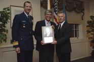 Steve Bellona, center, receives plaque from Rear Admiral J. Scott Burhoe (left) and Dr. Ray Cieplik.