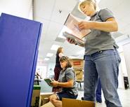 Robin Treen, foreground, and Patty Critelli, left, both custodial forepersons at Hamilton, and Danielle St. Pierre (background) of St. Elizabeth's, shelve books at the St. Elizabeth Family Practice in Utica.