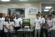 Hamilton students gather in the Bowery Mission kitchen with Prof. Erol Balkan.