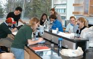 Prof. Pat Reynolds helps comparative literature students slice worms in interdisciplinary class.