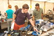 Students browse through electronic items in the Cram & Scram tent