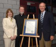 The Rev. John Croghan with president Joan Stewart and Mark Rice '73.