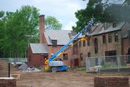 Workers remove the roof from the back of Emerson Hall