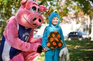 Matilda Terrell, 3, hangs out with Al Ham at Fall Fest. Matilda's mom is Assistant Professor of English Katherine Terrell.