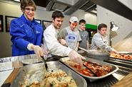 Men's lacrosse team members, from left, Kurt Minges '15, Mike Fiacco '13, Brandon Lew '16, James Hohm '14 and John Zimmerman '15, pack leftover food for the Rescue Mission.