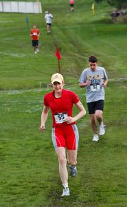  Mathematics professor Sally Cockburn on the cross-country course, followed by Daniel Kamenetsky '11.