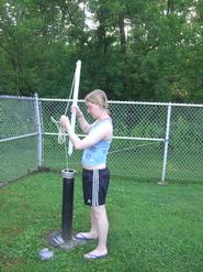 Hanna Kahrmann-Zadak '12 takes her daily sample from a well in Clinton village. 