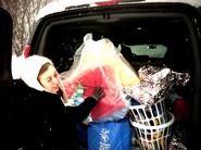 Mary Phillips '11, HAVOC Mitten Tree gift coordinator, loads presents.