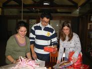 HAVOC officers Laurel Emurian '11, Brian Mizoguchi '11 and Kelsey Craw '11 organize gifts.