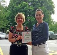 Colleen Pellman, left, accepts a plaque from Sarah Stevens of the American Heart Association.