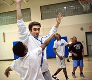 Eric Benvenuti '13 tries to block a shot during a game at the House of the Good Shepherd.