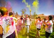 Students throw colored powder at each other during a Holi celebration on the Dunham Green.