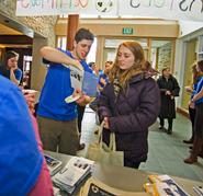 Ed Reed '13 explains the orientation schedule to Cameron Dunne '16 while new students sign-in at the Sadove Student Center.