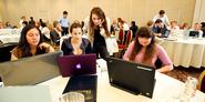 Peer advisor Lisa Labate '14, standing, assists (L to R) Catherine Luciani '15, Rebecca Hillel '15 and Elizabeth Buchanan '15 in an exercise during Sophomore JumpStart. 