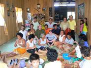 Michael Singer '09 and Craig Latrell with residents of Rumah Bain longhouse in Borneo.