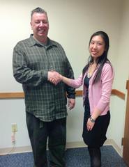 Lisa Yang of Hamilton Microfinance congratulates Joseph Rogers on his new loan.