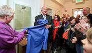 Art Massolo '64 and his wife Karen unveil the plaque in the new Days-Massolo Center.