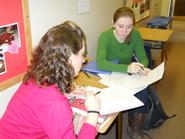 Amelia Mattern '12 (left) and Jane Rouse '12 work on math problems in the hallway at Christian Johnson.