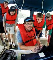 Prof. Mike McCormick maneuvers the remotely operated vehicle looking for a spot to collect bacteria samples from Green Lake. Looking on are Kevin Boettger, Matt Brzustoski, Rob Clayton and Daniel Lichtenauer.